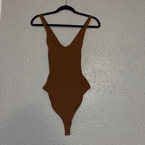 Nude body suit with a crossed back